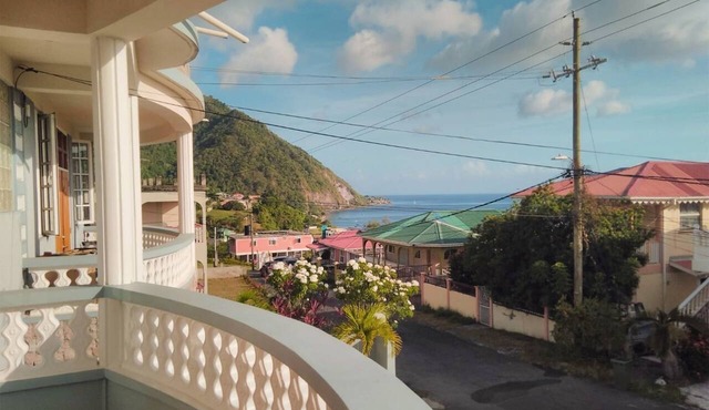 Hillside home with stunning sea views next to Roseau